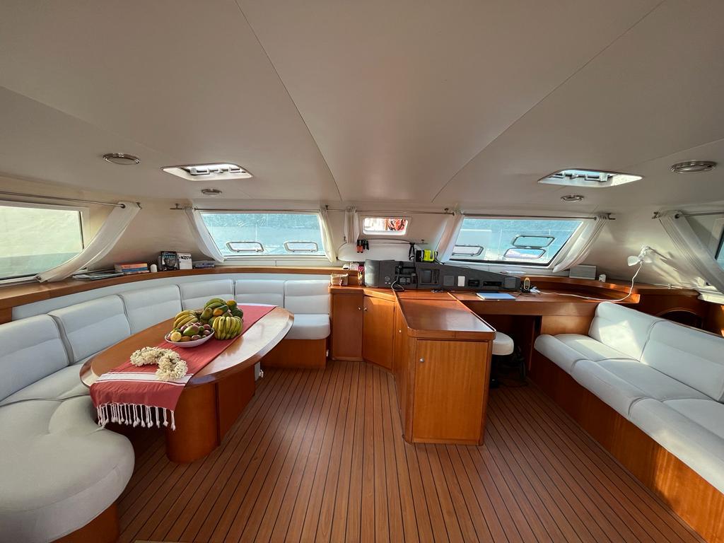 Interior of a family-friendly sailing catamaran with dining table and cabin
