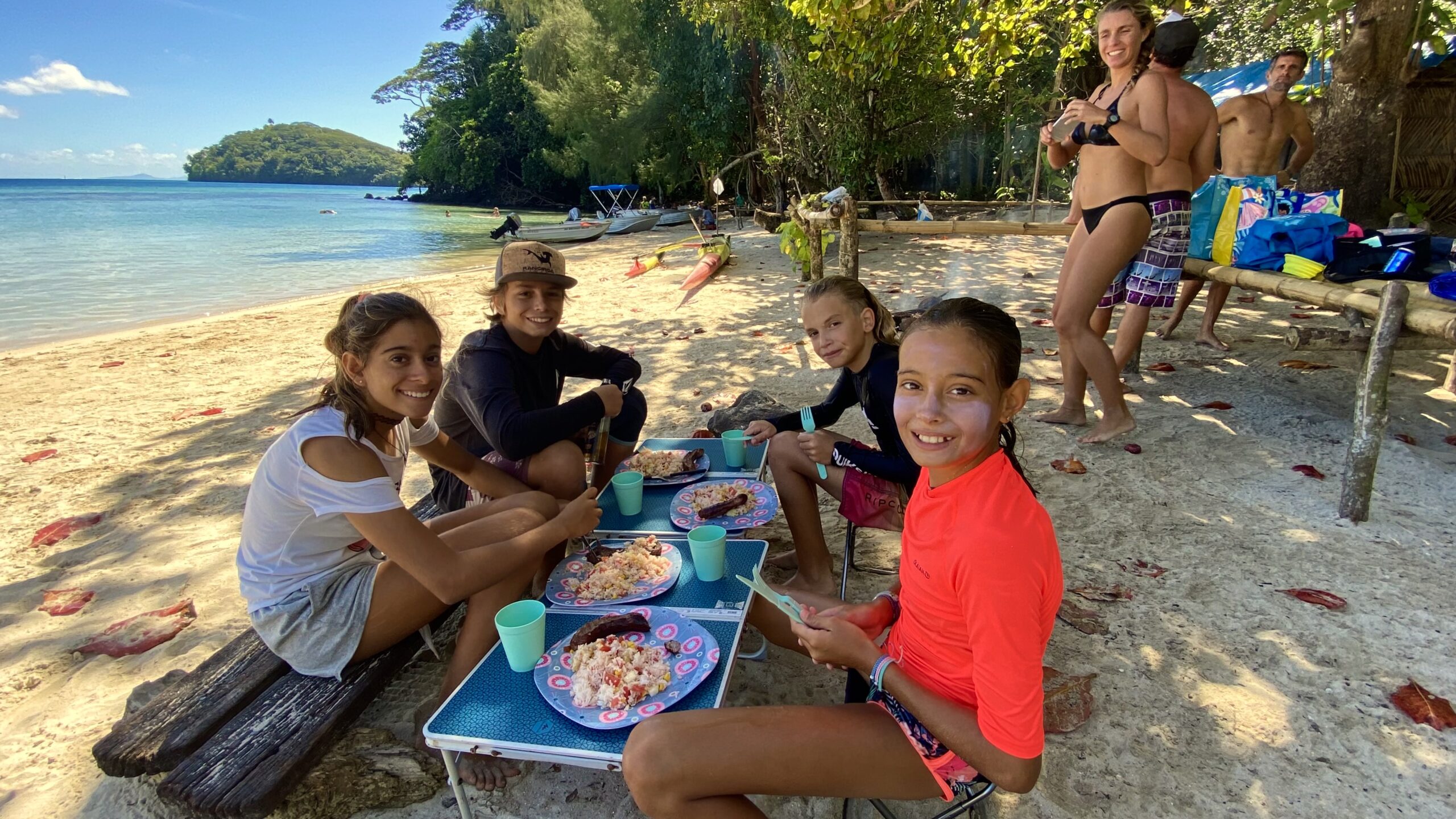 Group enjoying Polynesian-style BBQ on a boat