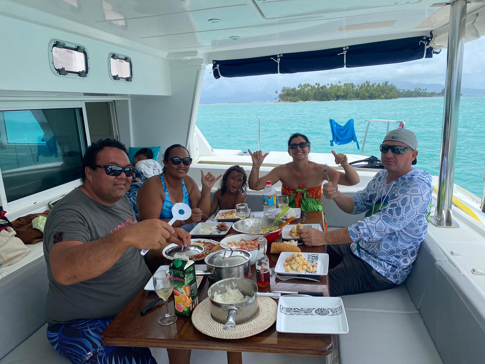 Group enjoying Polynesian-style BBQ on a boat
