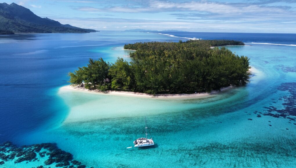 Sailing catamaran anchored near Mount Otemanu in Bora Bora