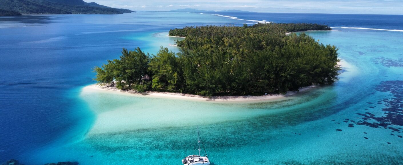 Sailing catamaran anchored near Mount Otemanu in Bora Bora