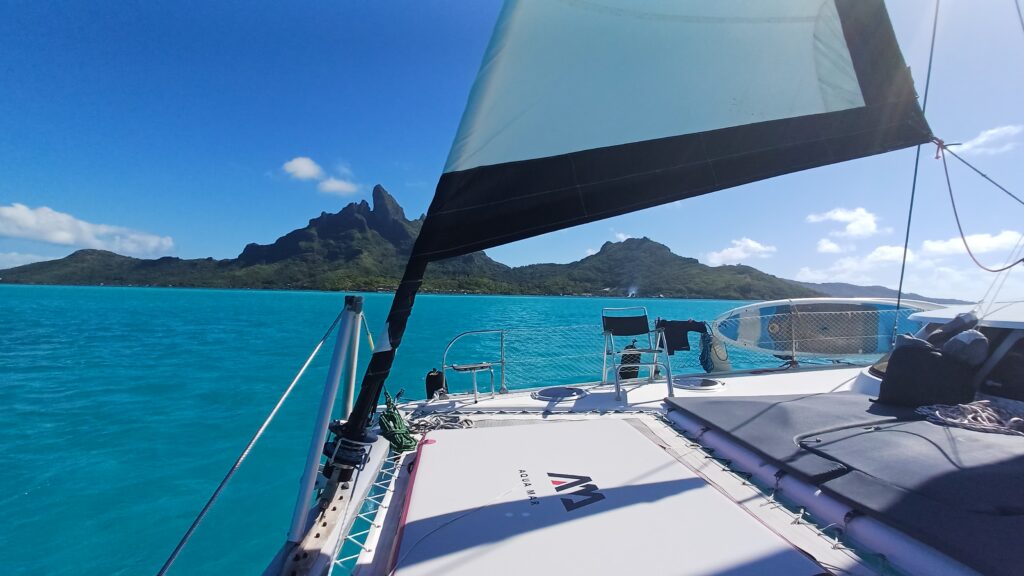 Sailing in the turquoise lagoon of Moorea during a short private catamaran cruise in French Polynesia.