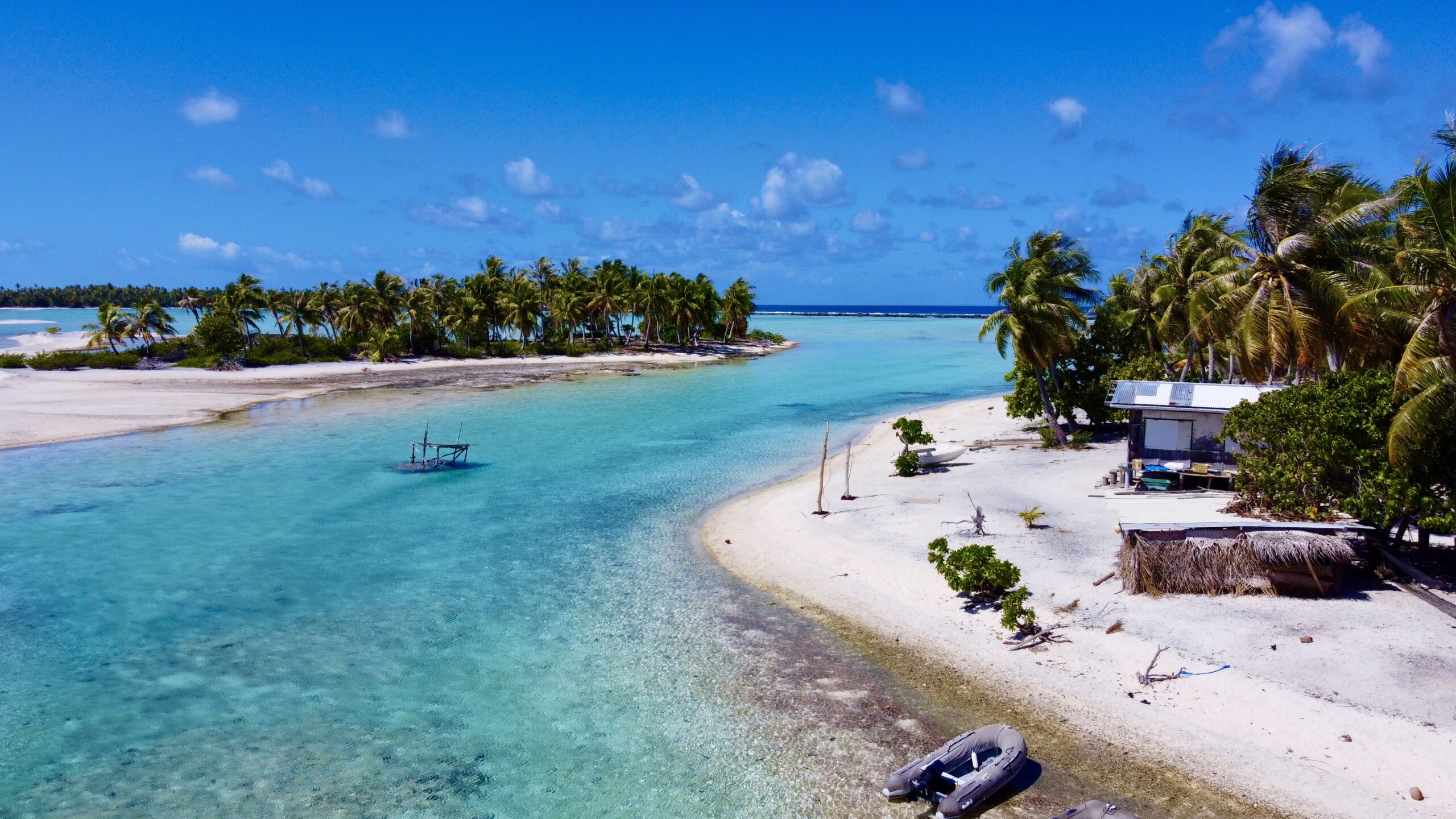 Catamaran sailing in the crystal-clear lagoon of Fakarava atoll in the Tuamotu Islands, French Polynesia