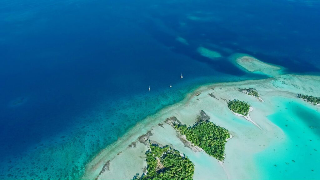 Catamaran anchored in the turquoise lagoon of Rangiroa atoll in the Tuamotu Islands