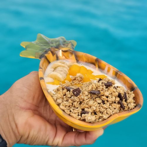 Guests enjoying fresh fruit platter during catamaran brunch